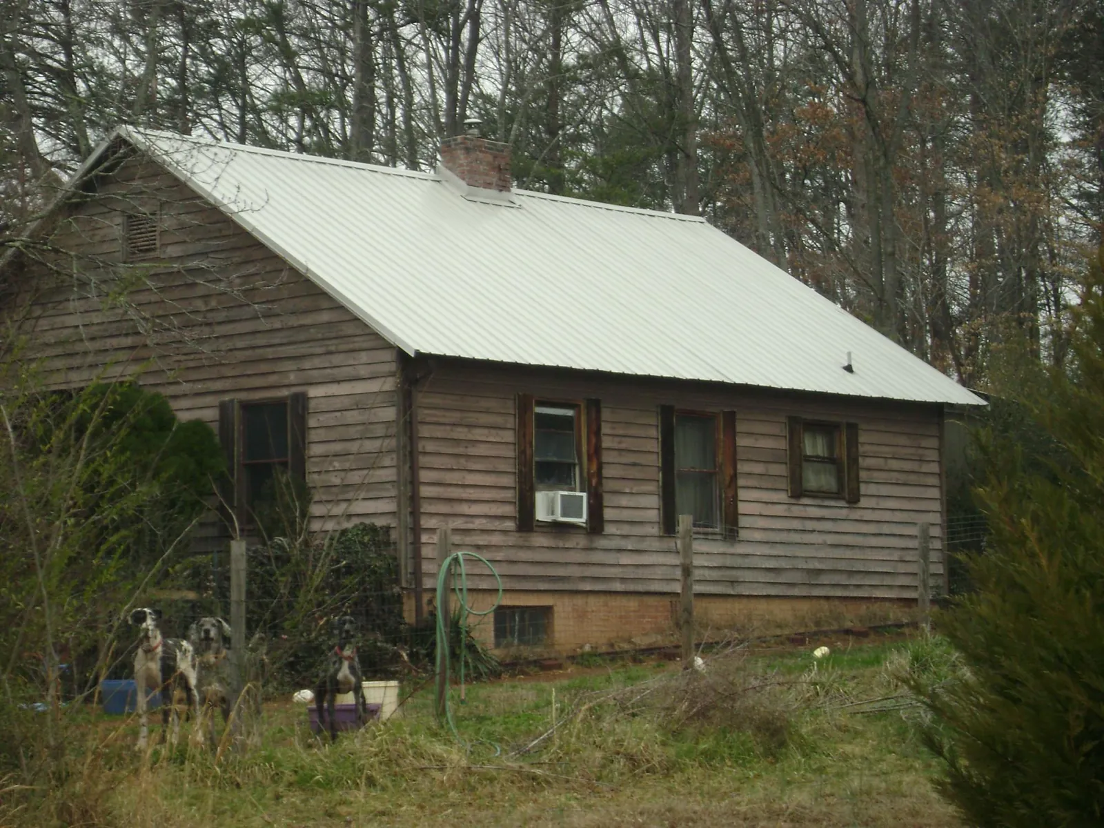 White metal roof on an old wood sided farmhouse, from a Metal Roof Installation job in Dilliner